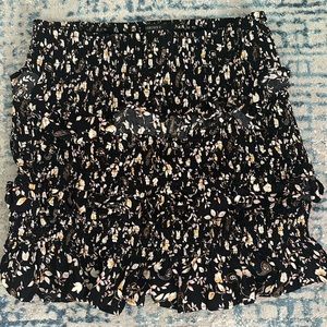 Floral tiered skirt, stretchy material. I would definitely call it a mini skirt